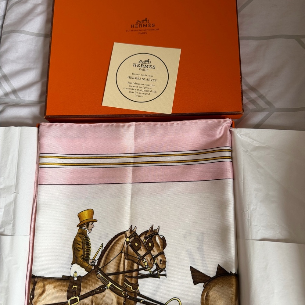 Hermès Coach & Saddle silk scarf in a signature orange box.